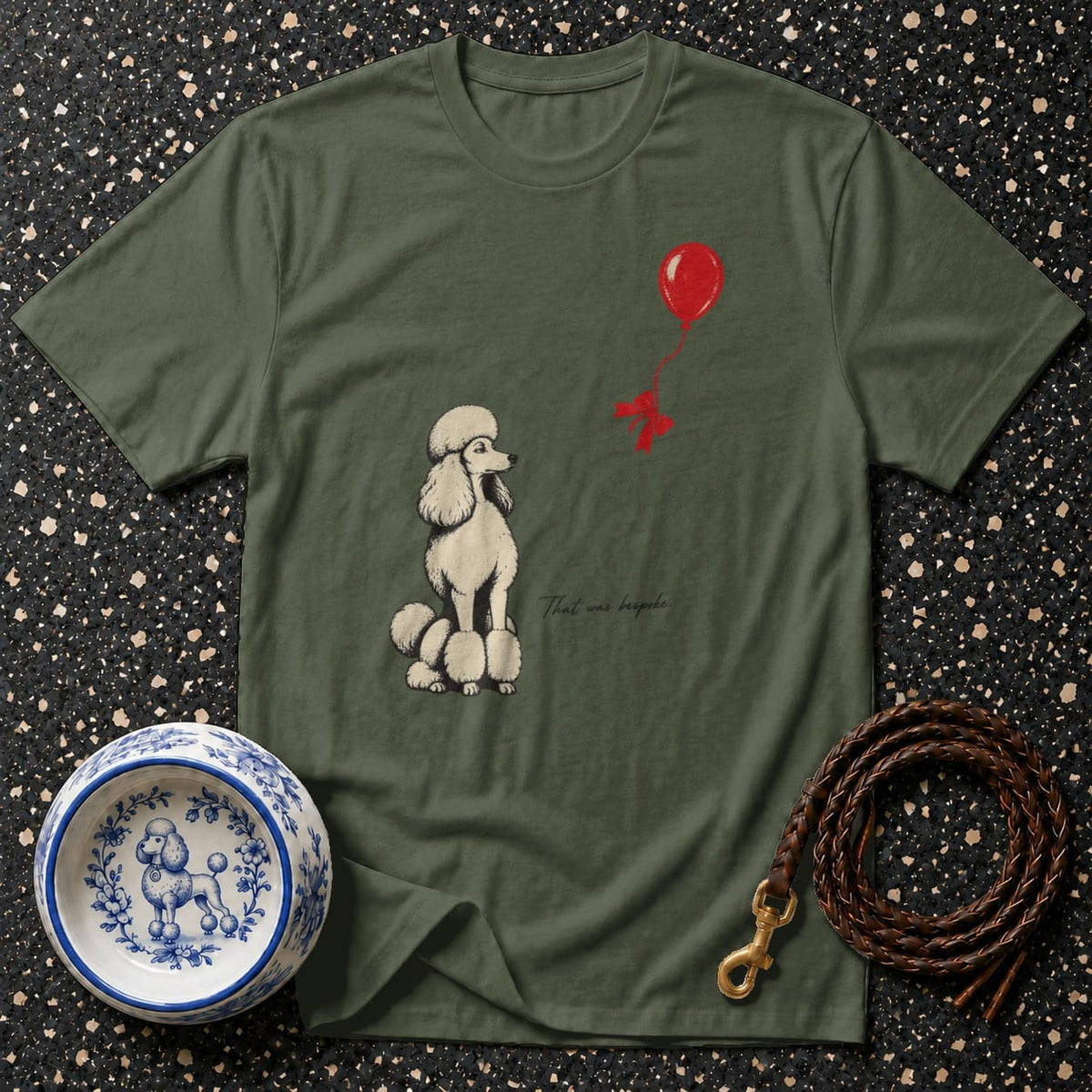 Green t-shirt with cream poodle and red balloon graphic and text.