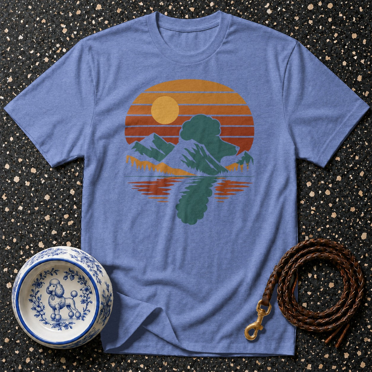 Blue t-shirt with retro mountain and lake sunset graphic and poodle dog bowl.