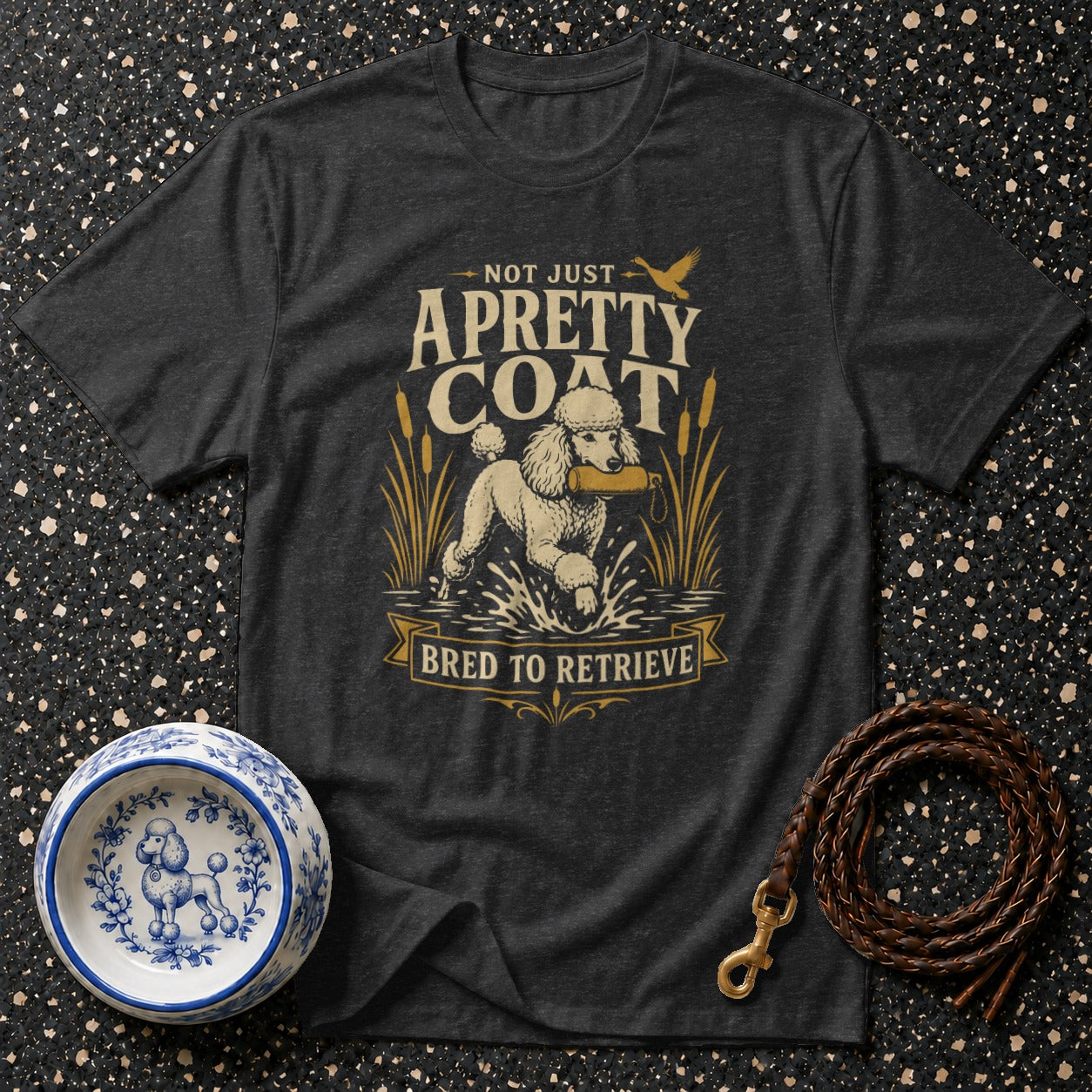 Dark t-shirt with "Not Just A Pretty Coat Bred To Retrieve" graphic featuring a retrieving poodle.
