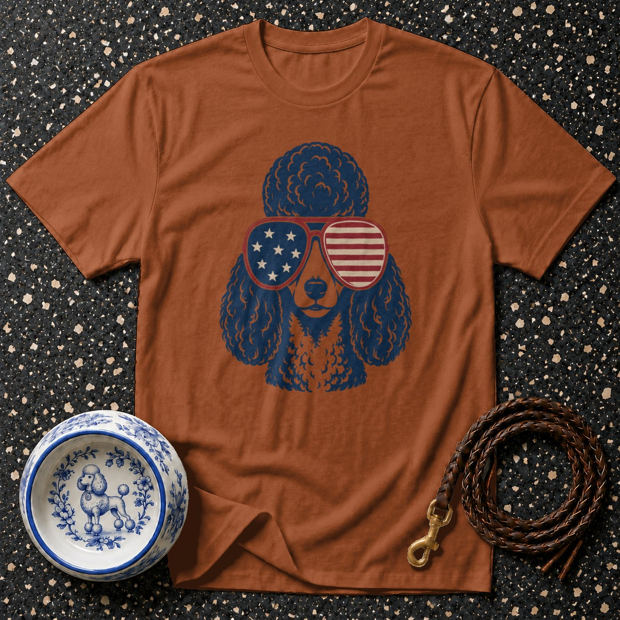 Brown t-shirt with a blue poodle wearing patriotic American flag sunglasses.