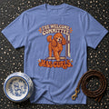 Light blue t-shirt with orange poodle graphic and text "THE WELCOME COMMITTEE HAS CURLS".