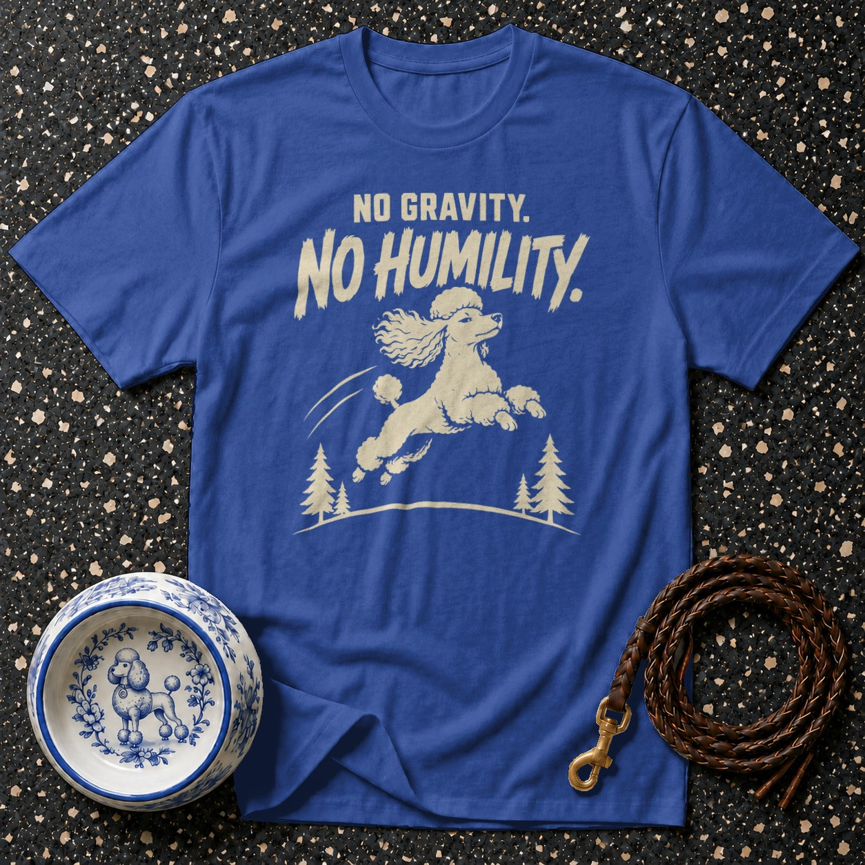 Blue t-shirt with text "NO GRAVITY. NO HUMILITY." and a jumping poodle graphic.